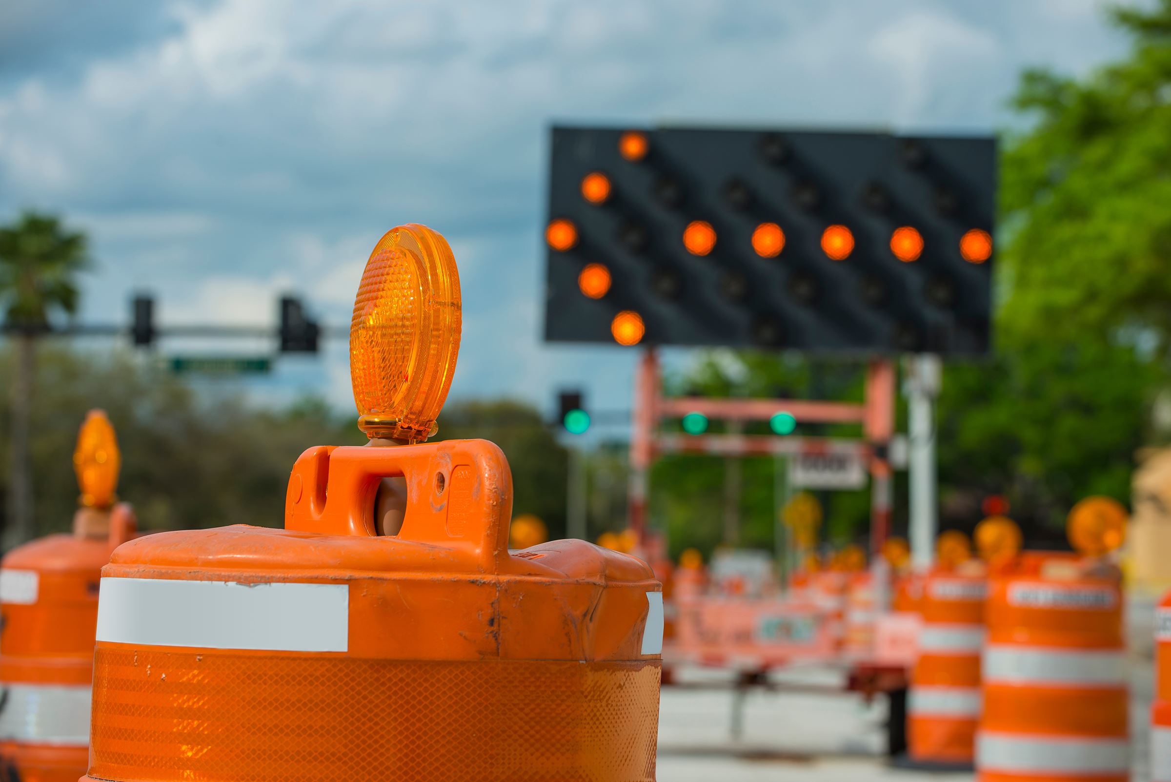 A lighted arrow sign directing drivers into another lane.